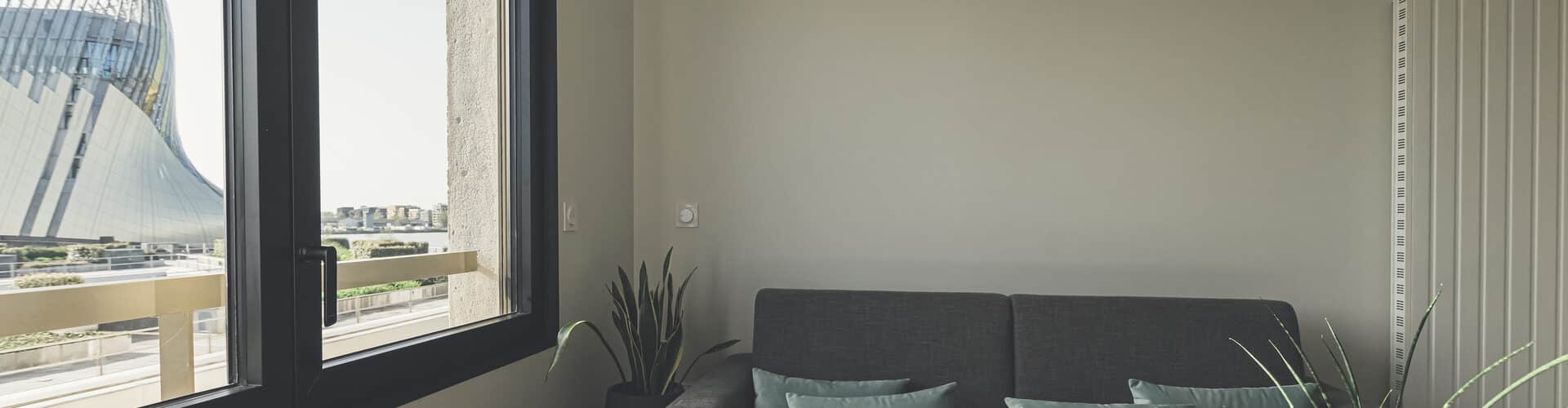 Comfortable and fully equipped T1 apartments at Whoo Residence Bordeaux Bacalan, featuring a stylish living room with a sofa bed, designed for flexible