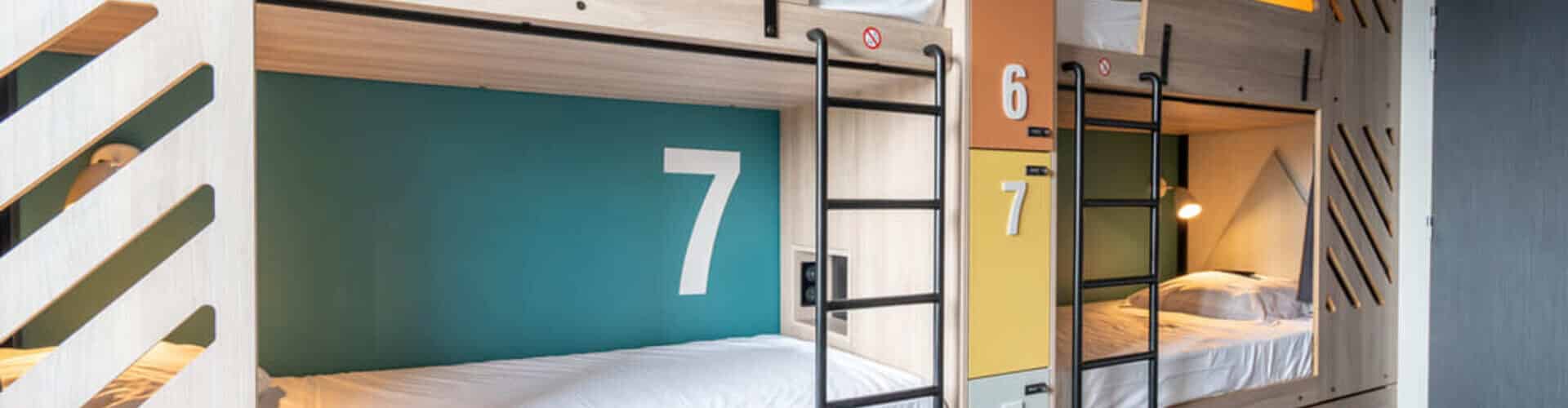 Bright and comfortable dormitory at Whoo Hostel Bordeaux Bacalan, offering semi-private sleeping pods with modern design.