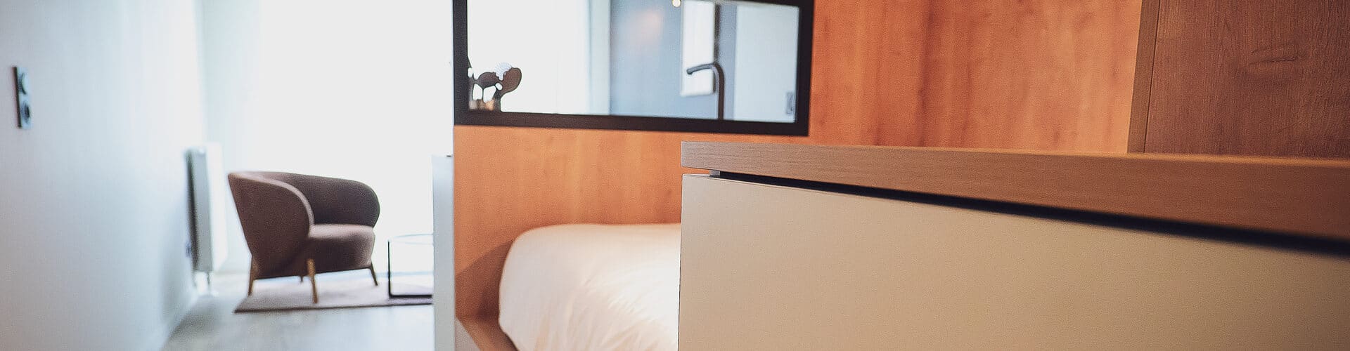 Modern furnished studio at Whoo Residence Rennes Gare, featuring a smartly designed interior with a functional kitchen and cozy sleeping area.